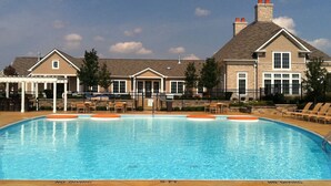A swimming pool with a 'No Diving' sign, lounge chairs, and a covered patio area. - BridgeStreet at Hilliard Grand (Dublin)