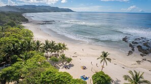 On the beach, white sand, sun loungers, beach umbrellas