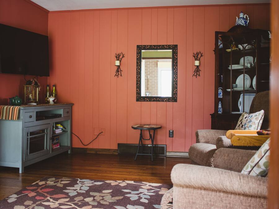 A living room with a television, a cabinet, a small table, and a sofa.