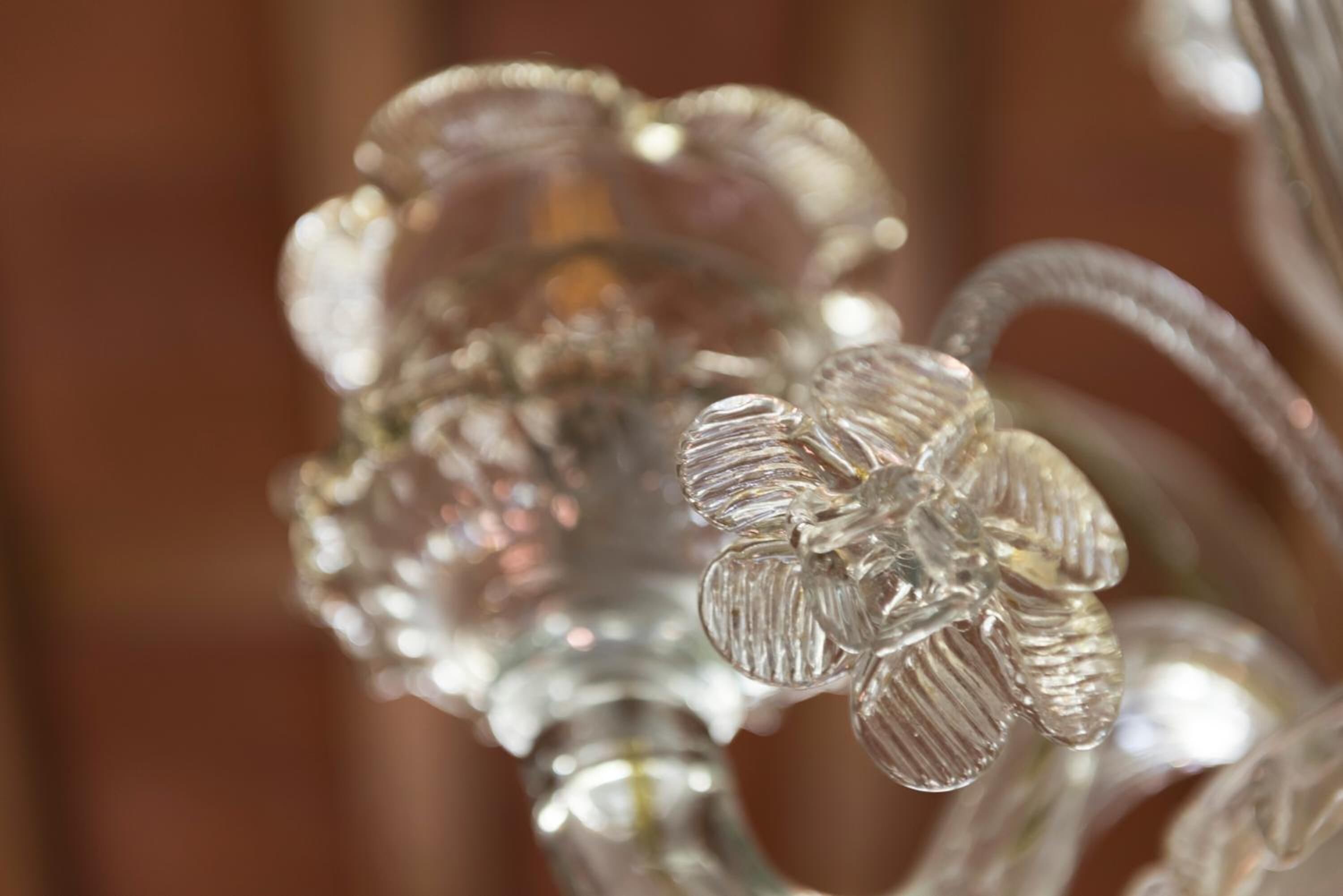A close-up of a glass object with a textured surface and a reflective quality.