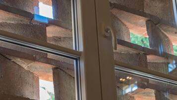 A window with a brick pattern and a white frame.