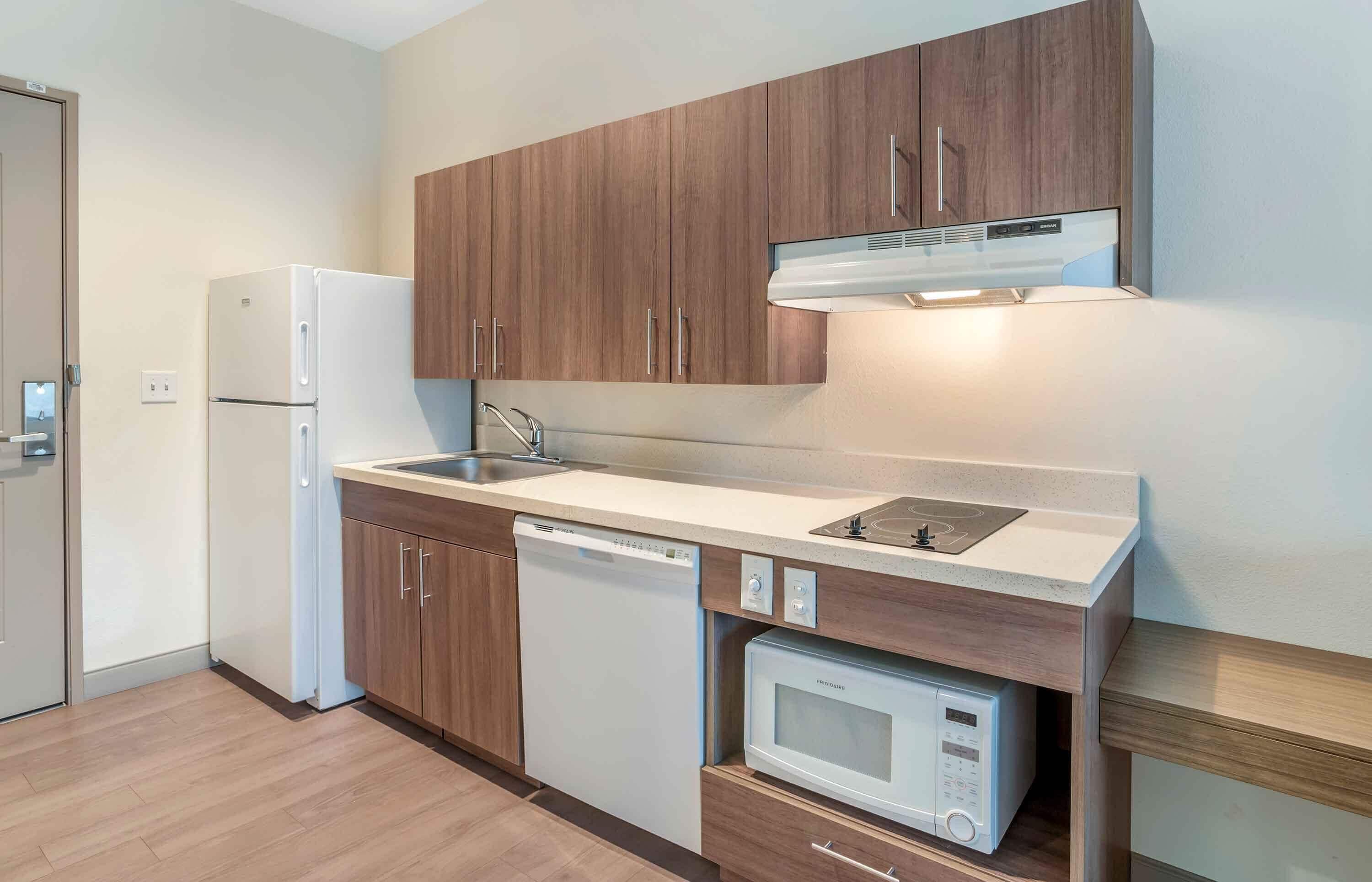 Full-size fridge, microwave, stovetop, cookware/dishes/utensils