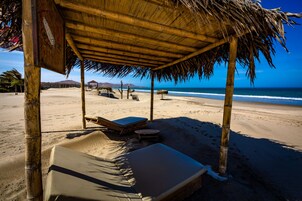 En la playa, sillas reclinables de playa, sombrillas