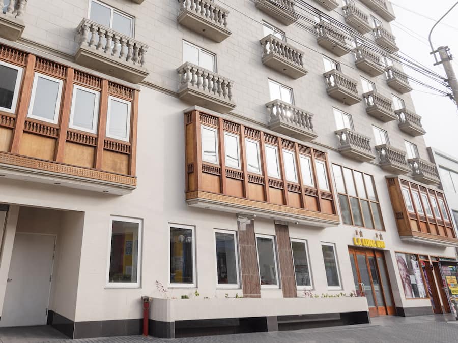 A multi-story building with a modern facade, large windows, and balconies.