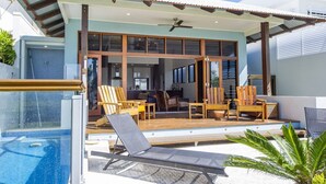 A modern house with a pool, outdoor seating, and a covered patio. - Beached on Magnetic (Picnic Bay)