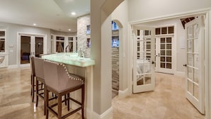 A spacious kitchen with a marble countertop and wooden chairs. - FIVE generous bedrooms and a REAL indoor Treehouse for kids  - see our VIDEO!! (Mission Viejo)