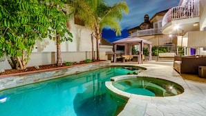 A swimming pool with a stone border, surrounded by a patio area with outdoor furniture. - FIVE generous bedrooms and a REAL indoor Treehouse for kids  - see our VIDEO!! (Mission Viejo)