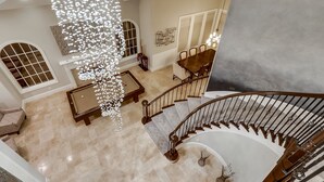 A spacious living area with a pool table, a dining table, and a staircase leading to an upper floor. - FIVE generous bedrooms and a REAL indoor Treehouse for kids  - see our VIDEO!! (Mission Viejo)