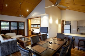 A modern interior with a dining area, kitchen, and living space.