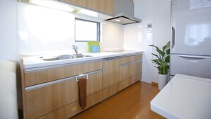 A modern kitchen with wooden cabinets, a stainless steel sink, and a built-in dishwasher. - 4-bedrooms 2-toilet 2-bathroom near FushimiInari with free parking (Kyoto)
