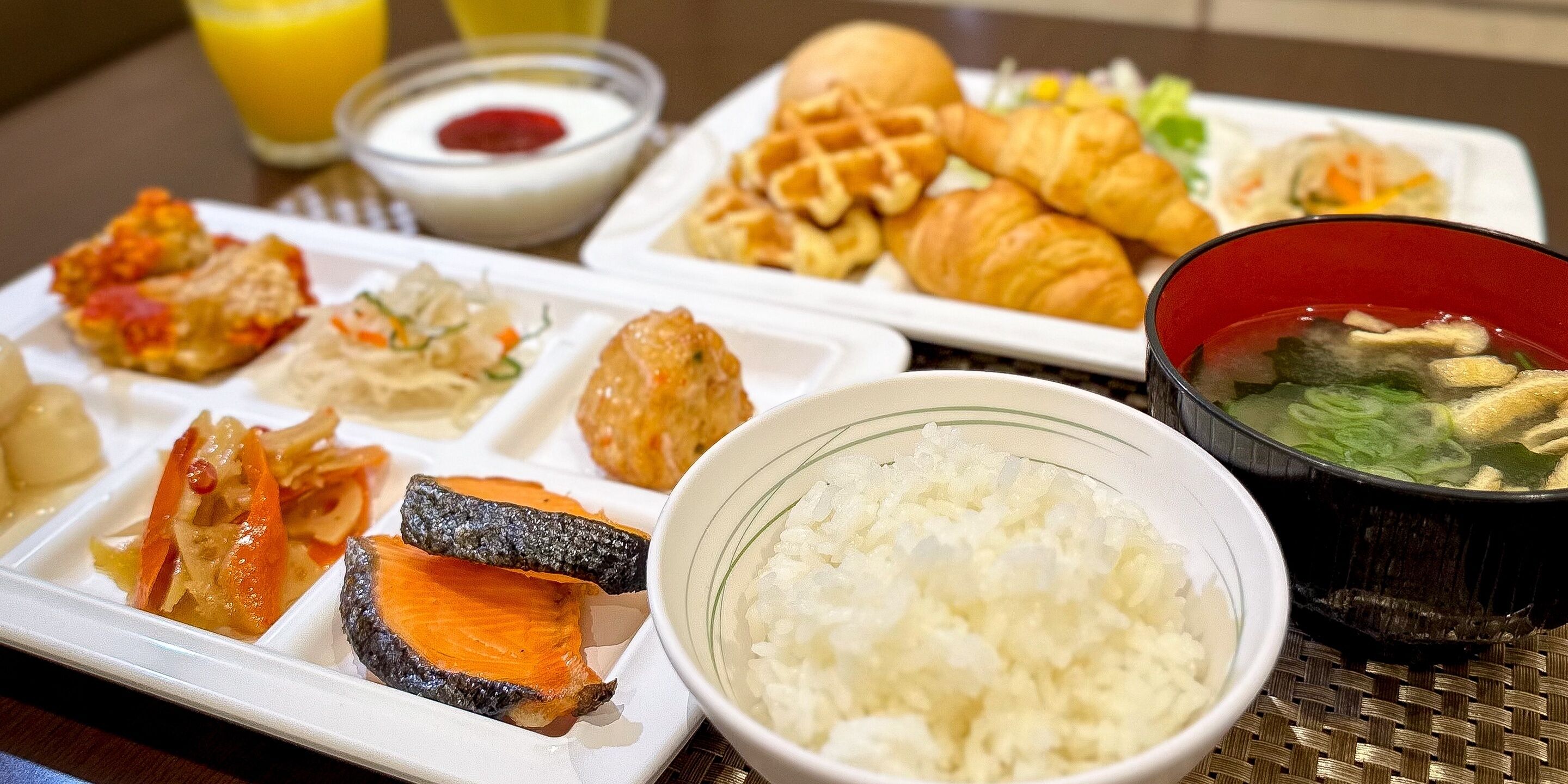 A meal tray with various dishes including rice, vegetables, and a soup bowl.