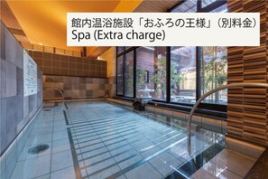 A spa with a tiled floor, a wooden wall, and a window with a view of the outside.