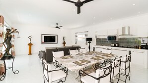 A modern kitchen with white cabinets, a built-in oven, and a microwave. - Wirason Villa 4 Bedrooms (Koh Samui)
