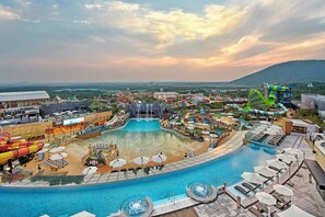 A water park with a large pool, slides, and a waterfall attraction. - Shinhwa Jeju Shinhwa World Hotel & Resorts (Seogwipo)