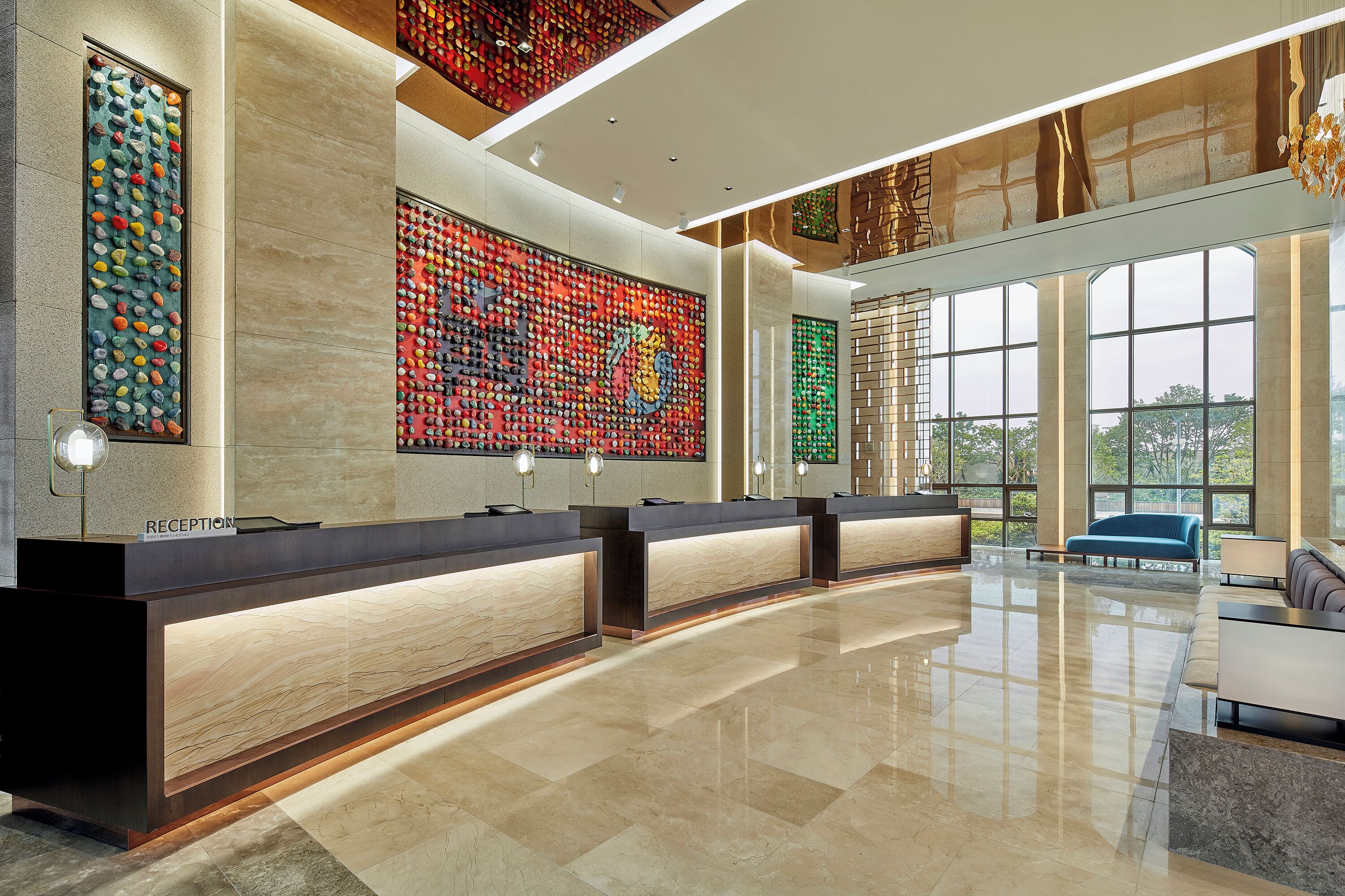 A reception area with a marble counter, large windows, and a modern interior design.