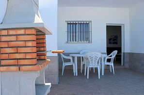 Enjoy al fresco dining with a barbecue grill and outdoor seating for four.