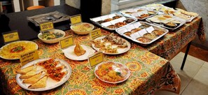 A buffet table with various dishes and labels indicating prices.