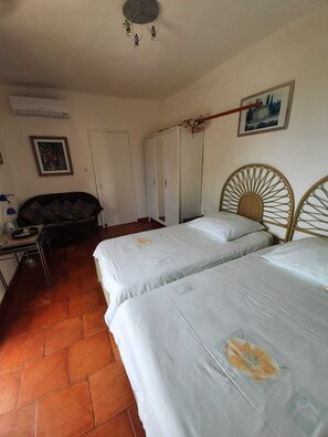 A bedroom with two beds, a wardrobe, a desk with a lamp, and a ceiling fan. - Paradise (customer´s evaluation) (Lagoa)