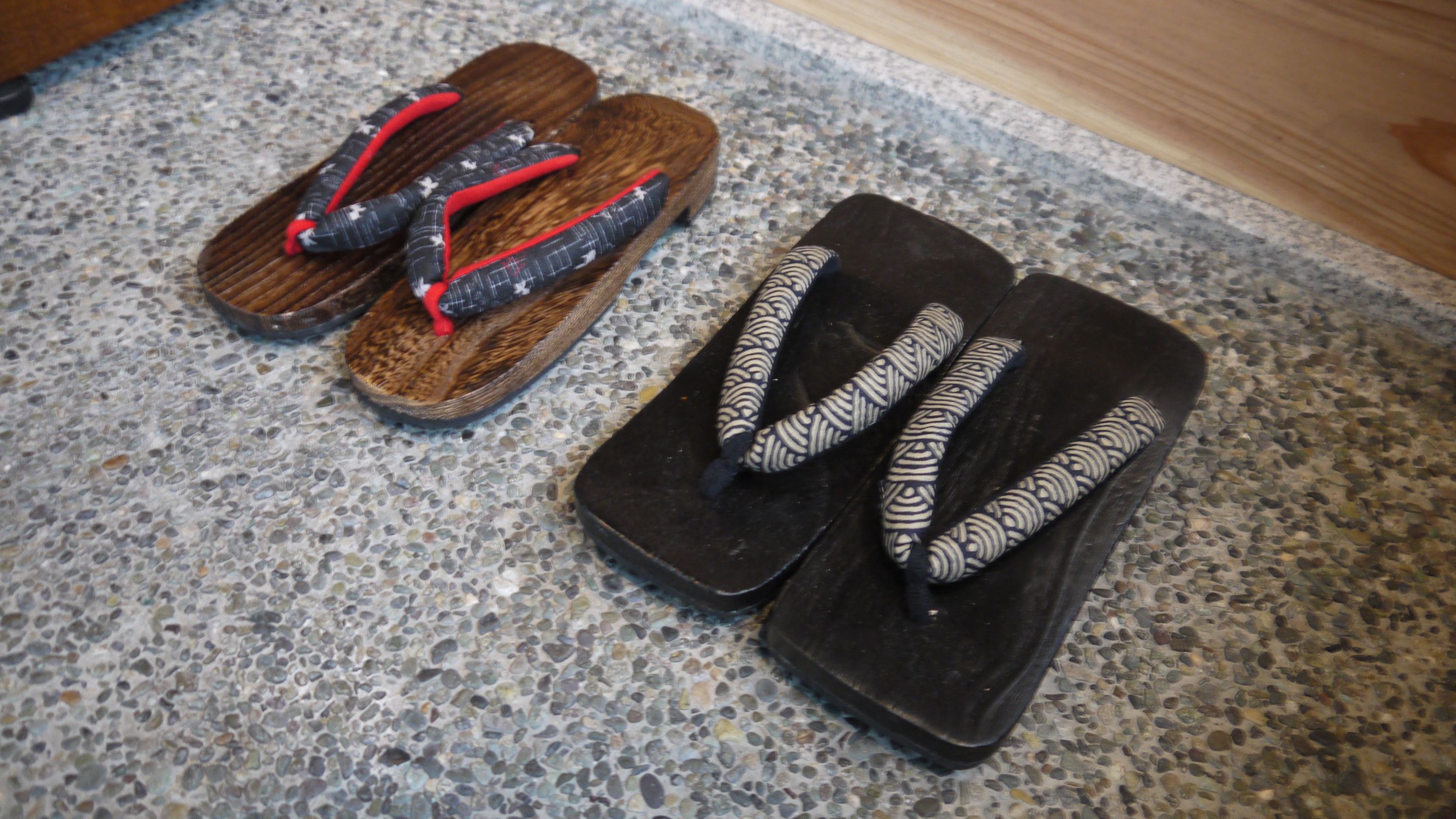 A pair of flip-flops on a terrazzo floor.