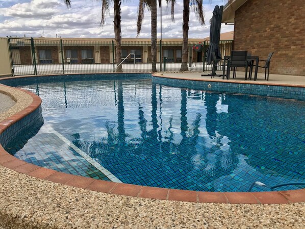 Outdoor pool, open 7 AM to 9 PM, pool loungers