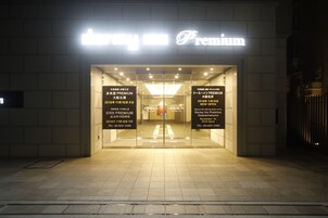 The entrance of a hotel with a prominent sign reading "Premium".