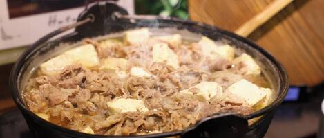 A hot pot with tofu and meat.
