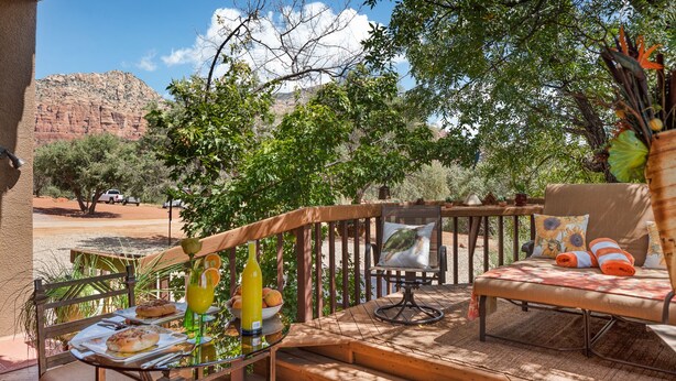 A patio with a wooden deck, outdoor seating, and a view of a mountain. - Pet Friendly
Hike, Bike, Enjoy! (Sedona)