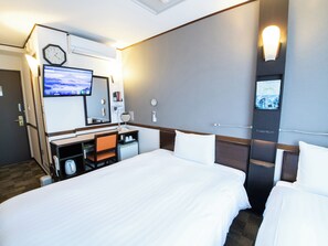 A hotel room with a bed, a desk with a chair, a TV, a clock, and a mirror. - Toyoko Inn Toyama Station Shinkansen 2 (Toyama)