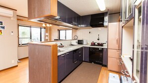 A compact kitchen with a microwave, stove, and refrigerator. - Shirakabanoyado-Minato (Osaka)