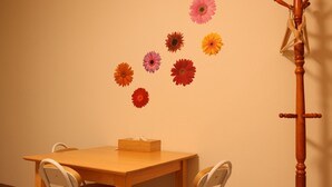 A room with a wooden table, two chairs, and a wooden stand with a cloth. - Shirakabanoyado-sakuragawa (Osaka)