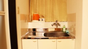A compact kitchenette with a sink, a coffee maker, and a small countertop. - Shirakabanoyado-sakuragawa (Osaka)