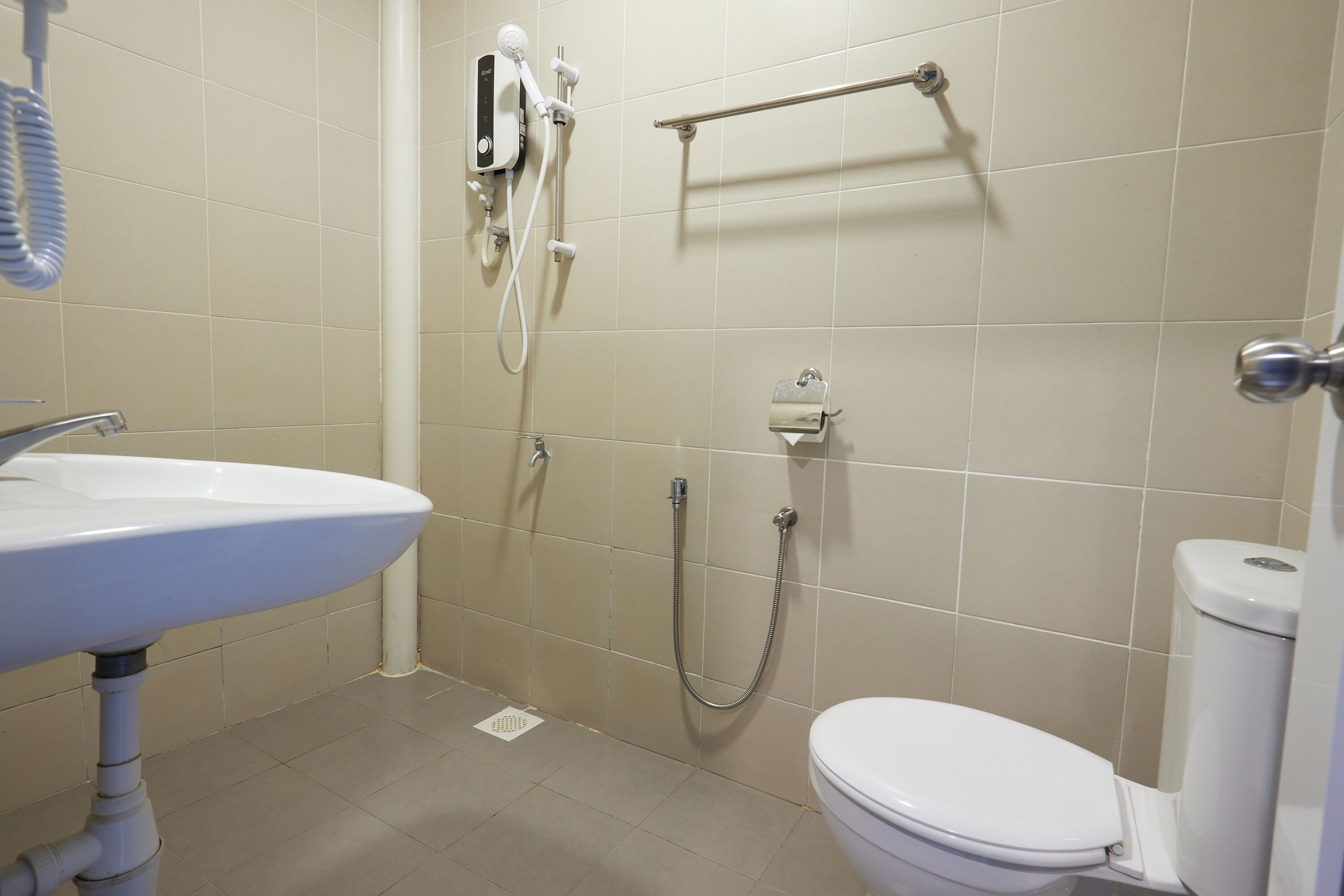 A bathroom with a sink, toilet, and shower.
