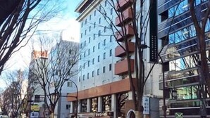A multi-story hotel with a modern architectural design, featuring balconies and large windows. - Hotel Johzenji (Sendai)