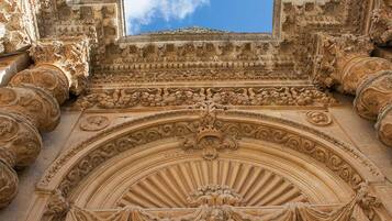A detailed stone facade with intricate carvings and a central archway.