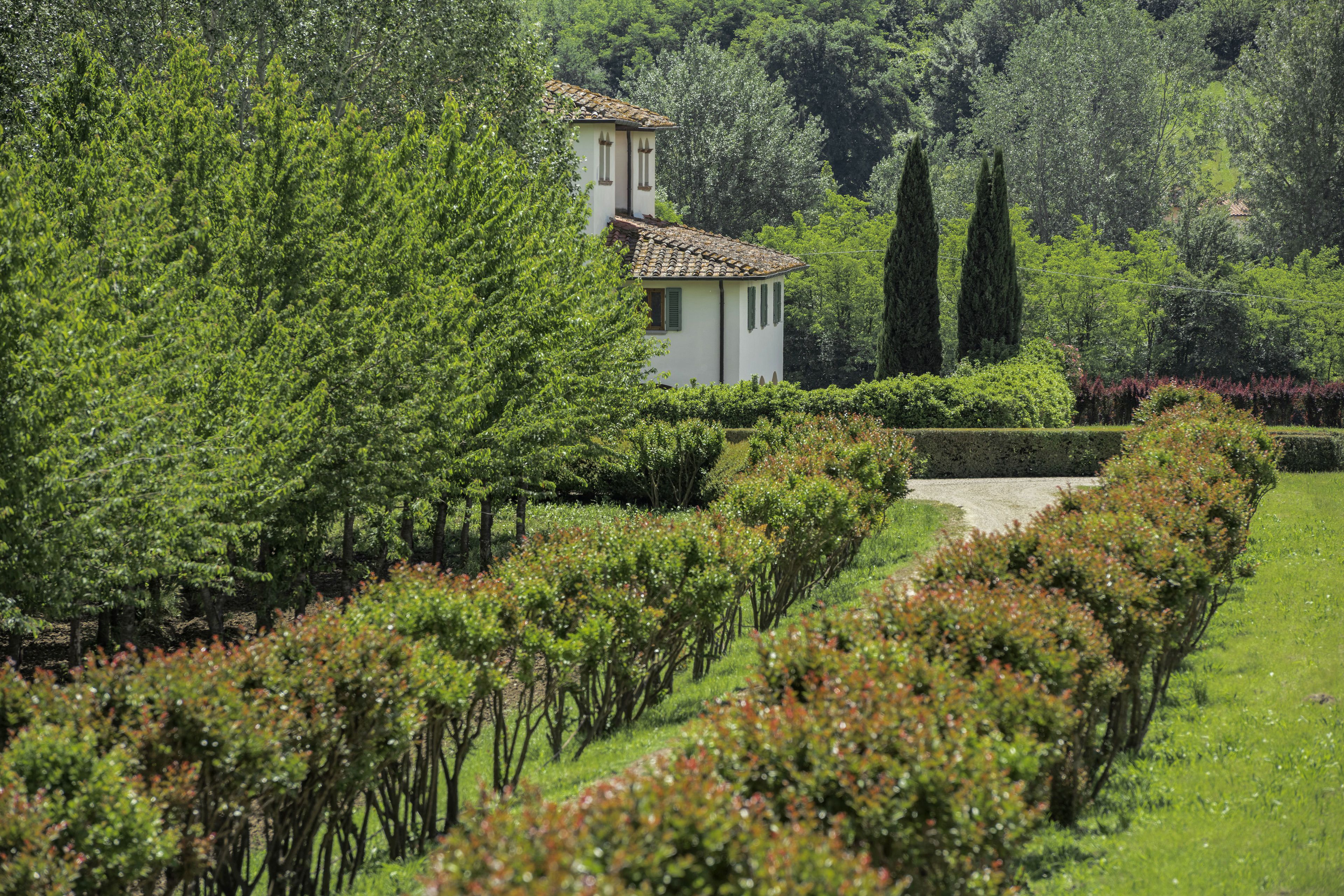Una villa rodeada de exuberante vegetación y un jardín cuidado.