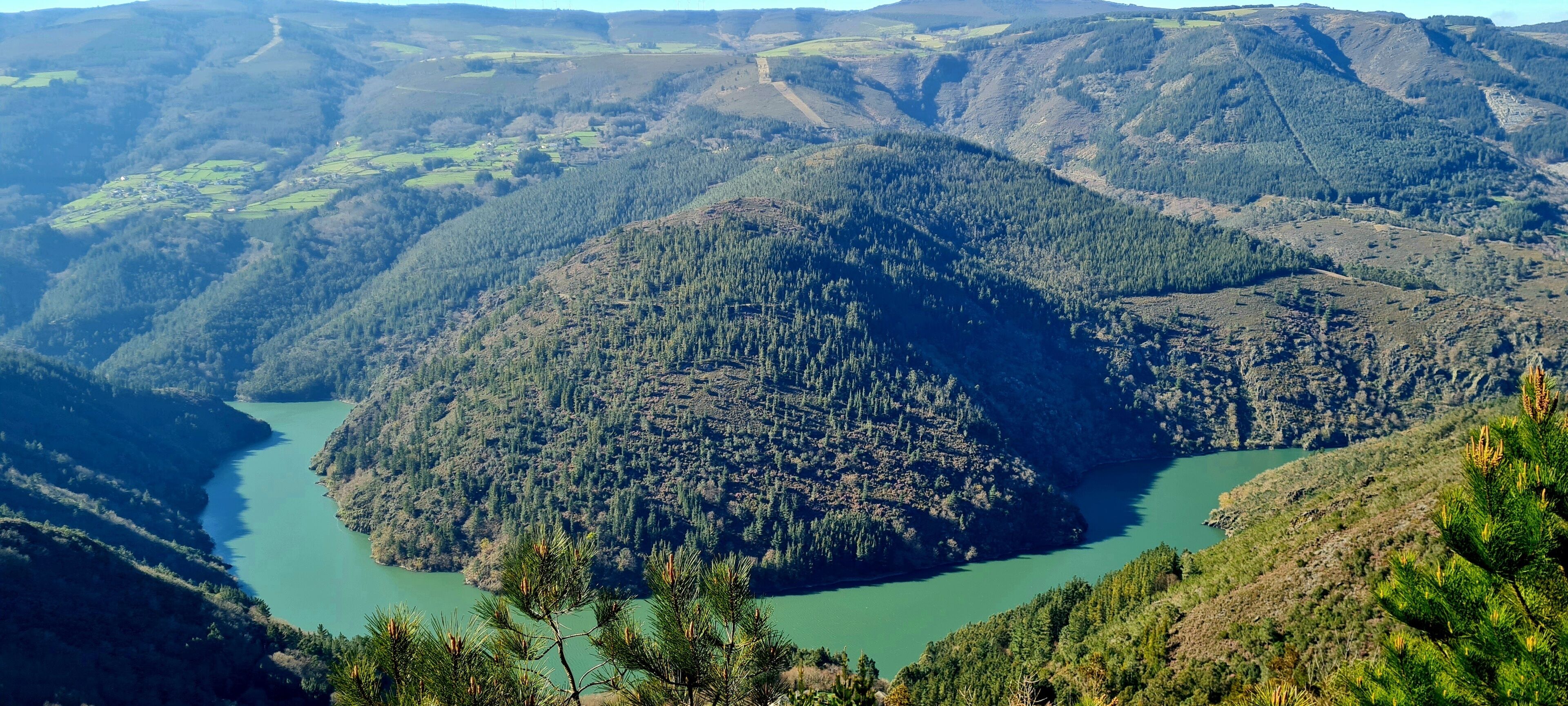 A mountainous landscape with a river.