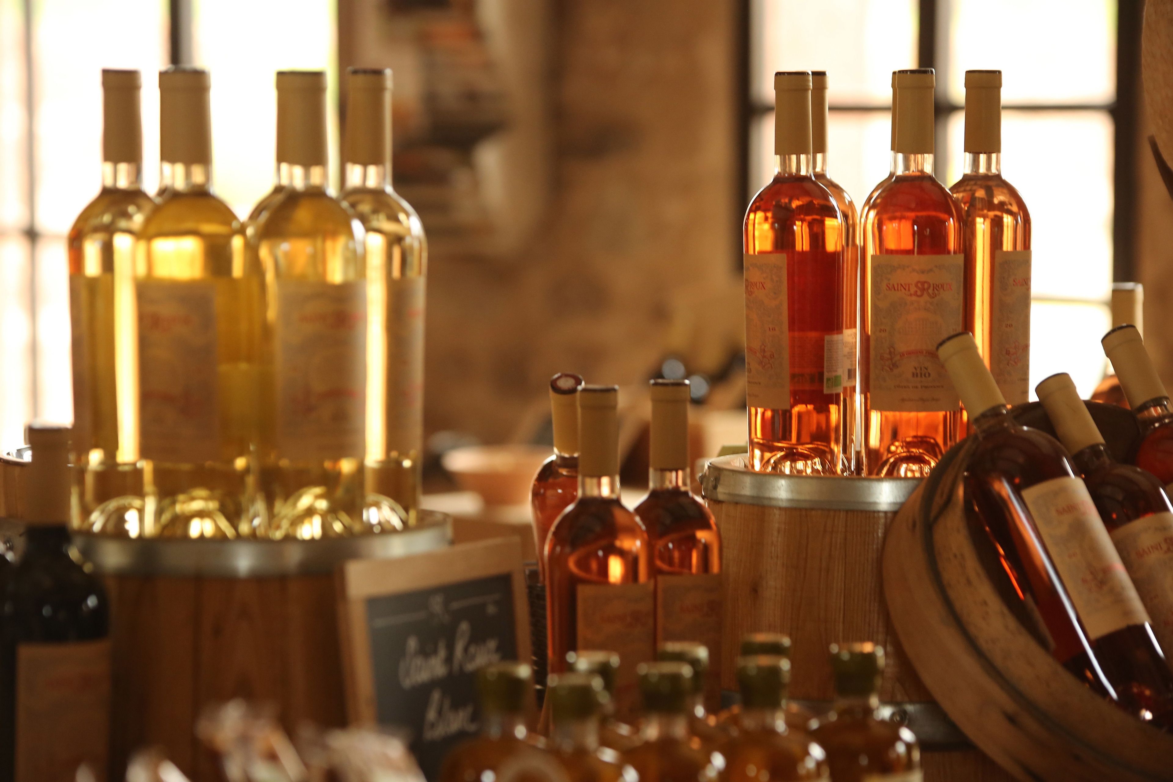 Botellas de vino exhibidas en un cesto de madera y un balde.