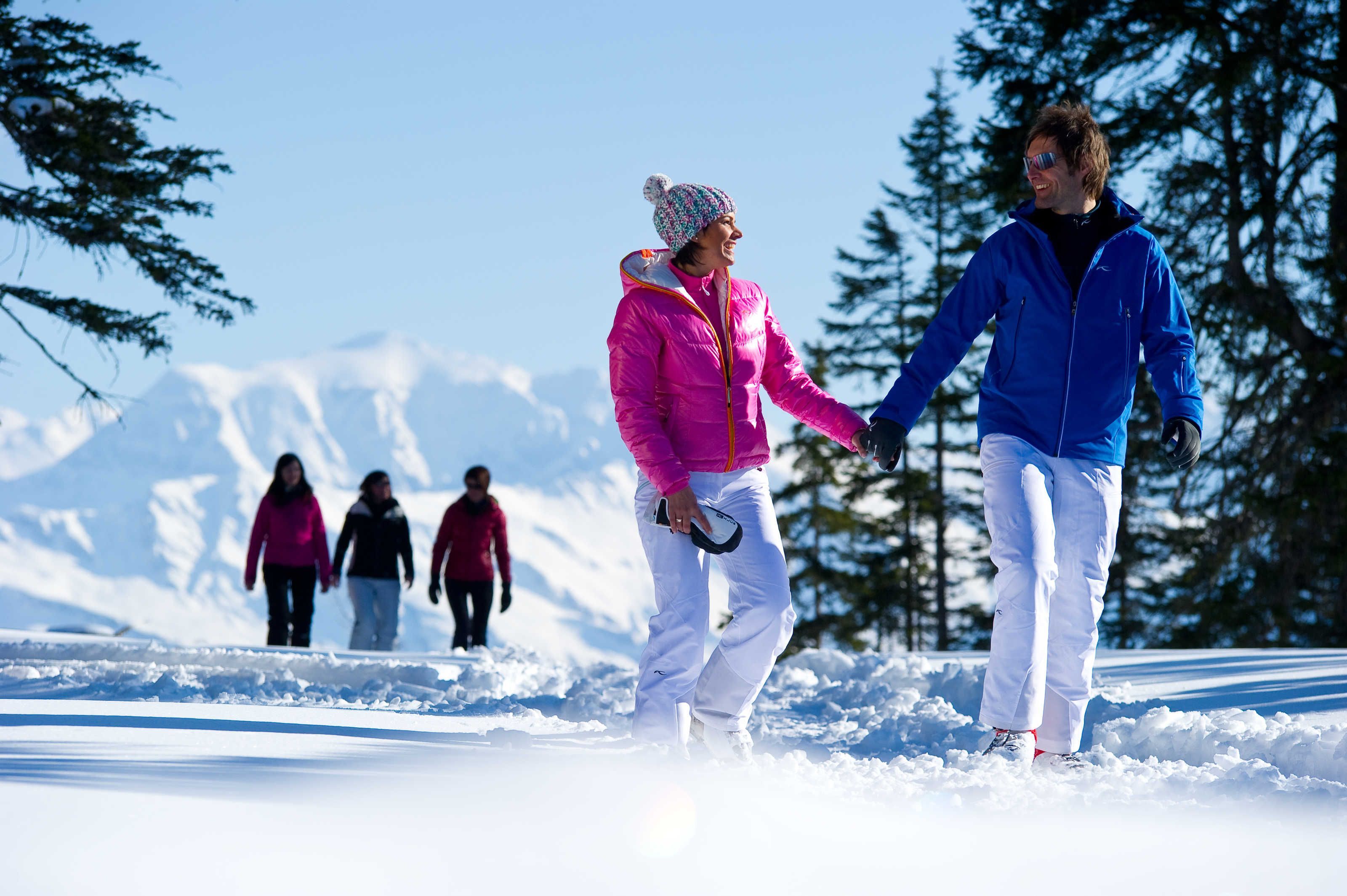 A snowy outdoor scene with people walking.
