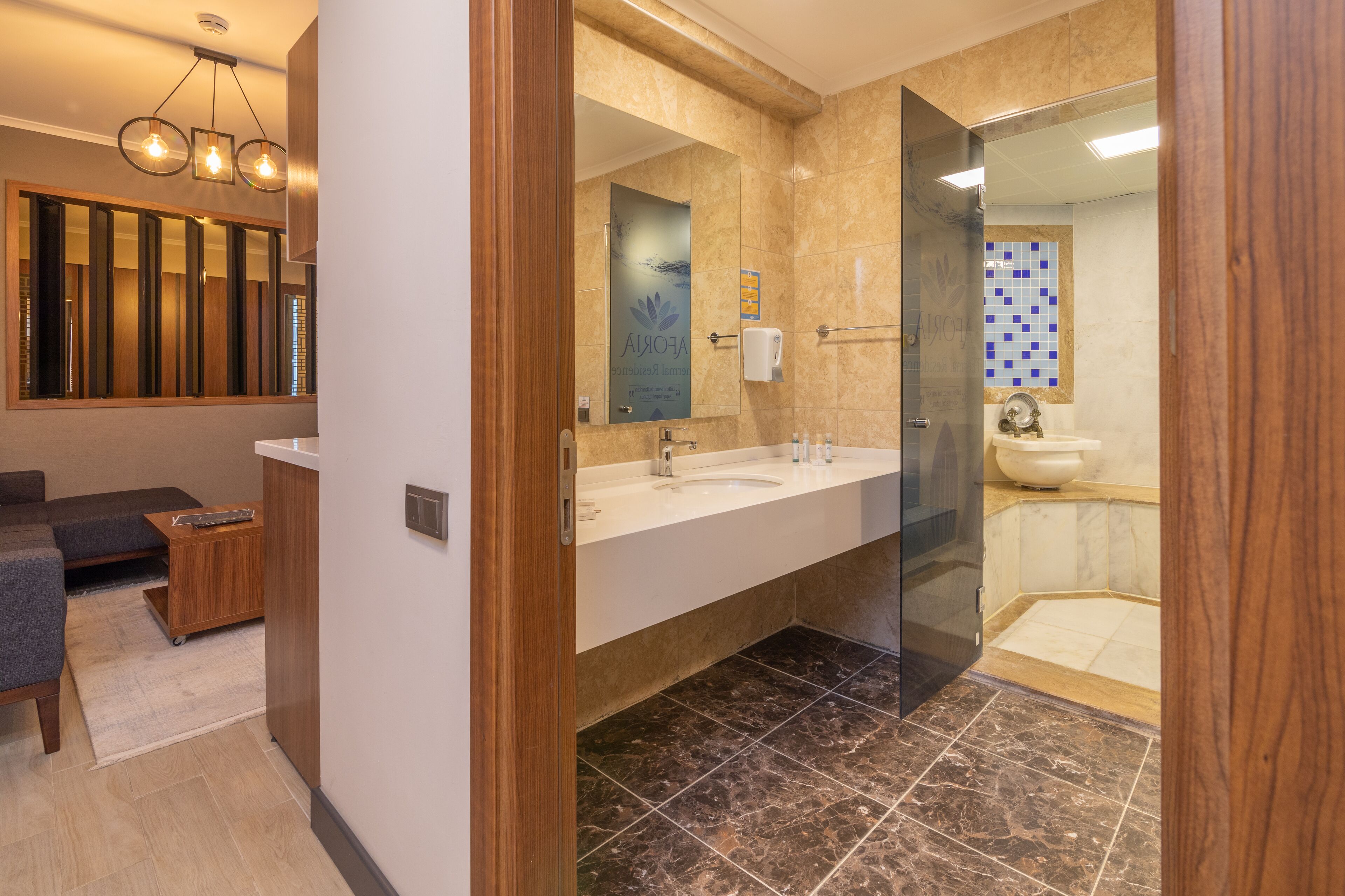 A modern bathroom with a large mirror, dual sinks, and a separate shower area.