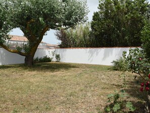 Enjoy a serene outdoor space surrounded by lush trees and a well-manicured lawn.