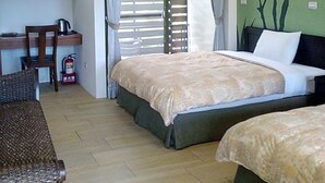 A room with two beds, a desk, a chair, and a kitchenette. - Moonrise Inn (Donghe)
