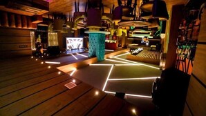 A modern interior with wooden flooring, geometric light patterns, and hanging kitchen equipment. - JD Hotel Four Boutique (Jaipur)