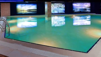 Relax by the pool surrounded by serene natural scenes on large screens and lounge in style on the comfortable poolside seating.