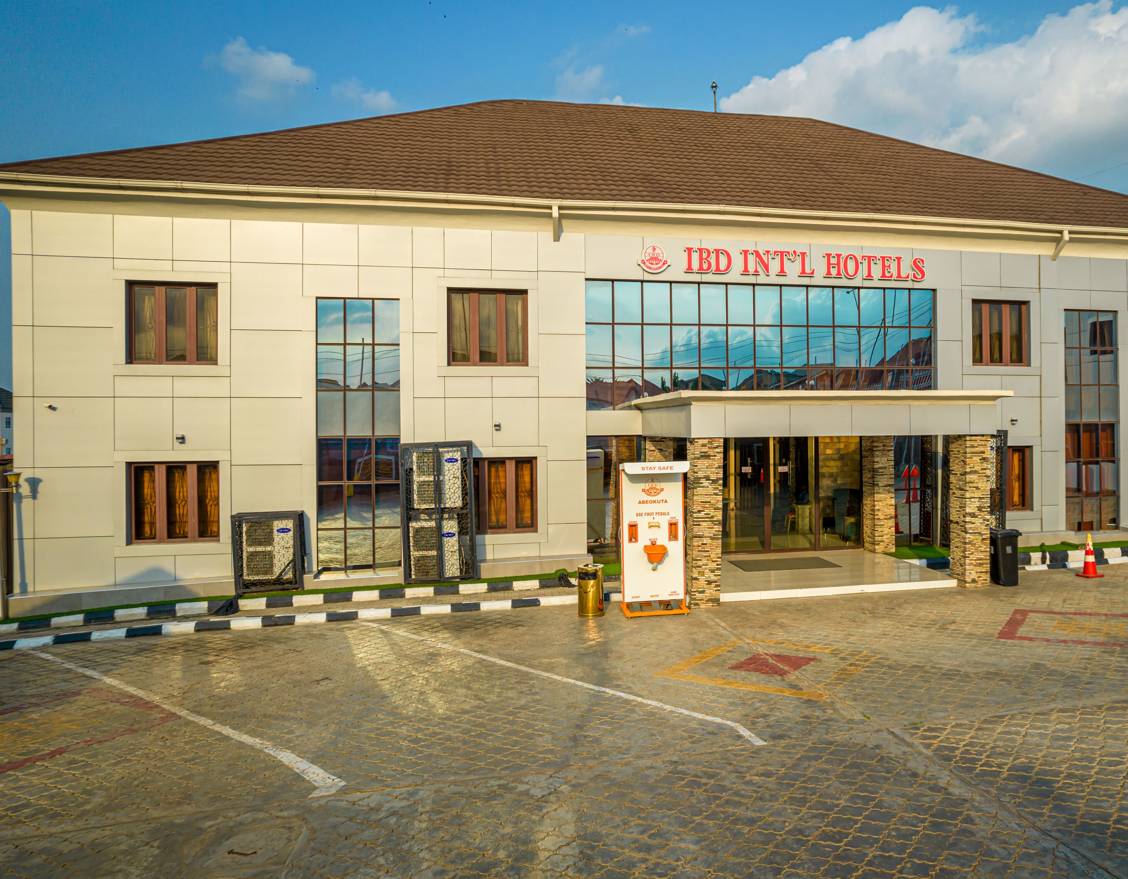 A hotel with a modern facade, large windows, and a sign indicating it is an international hotel.