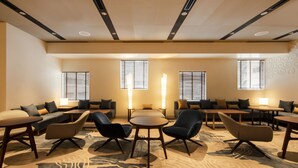 A hotel lobby with a seating area, tables, and a patterned carpet. - karaksa hotel premier Tokyo Ginza (Tokyo)
