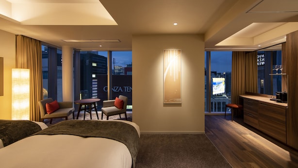 A hotel room with a large bed, a desk, a chair, and a view of the cityscape. - karaksa hotel premier Tokyo Ginza (Tokyo)