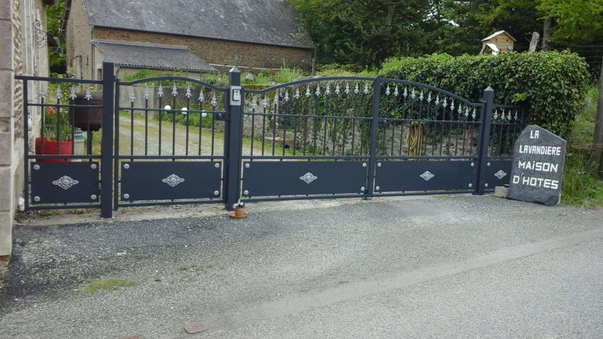 A gated entrance to a property with a sign indicating it is a house of rest.