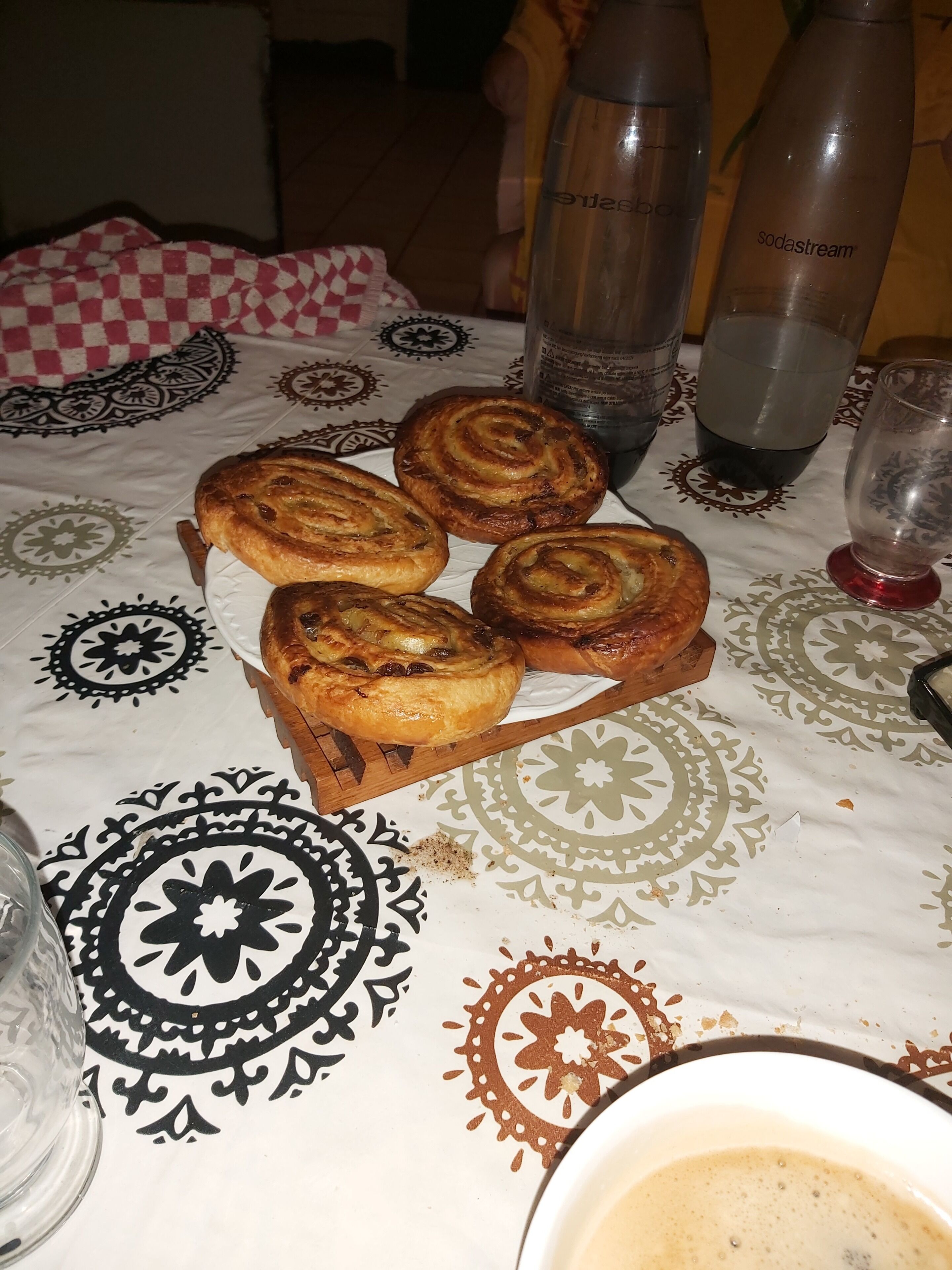 A table with pastries, a glass of water, and a cup of coffee.