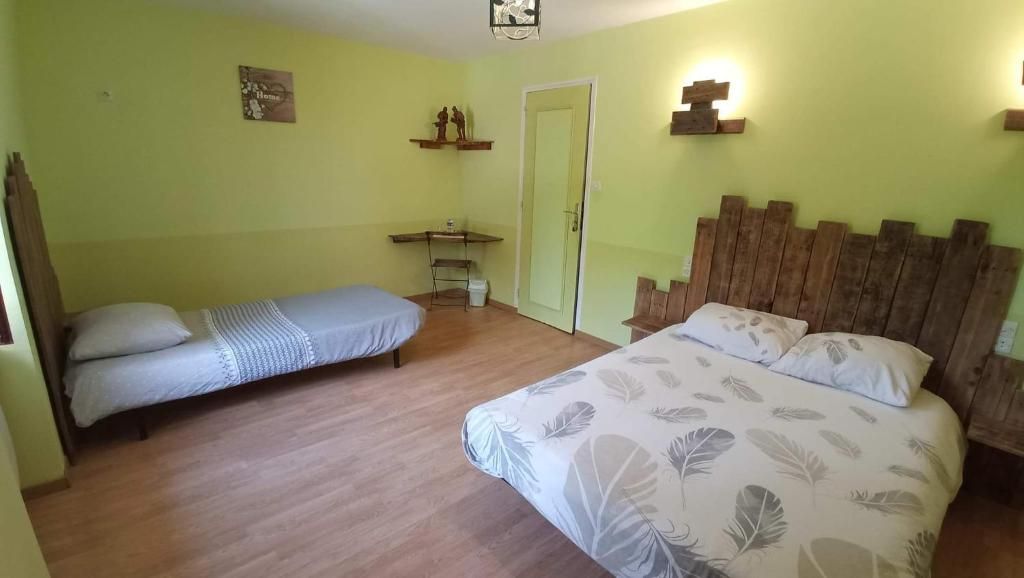 A room with two beds, a desk, and a door.