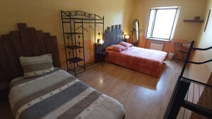 Een slaapkamer met een bed, een stoel, een kledingkast en een raam.